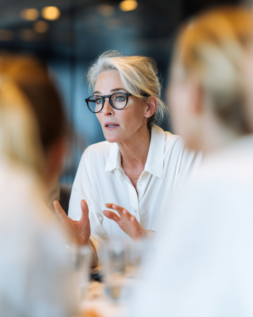 team.tmg_A_senior_british_woman_in_business_attire_is_speakin_d6a8cc8e-f31f-4a94-85e0-3203dd93cea2_0